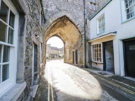 An outdoor area with a stone archway and buildings at Rooftops Lindale