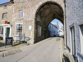 An archway leading to a street with shops at Rooftops in Lindale