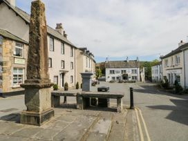 A street view featuring buildings and a stone pillar at Rooftops in Lindale