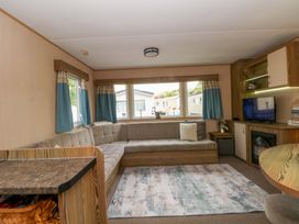 A living room with a sofa and television at Kensington 49