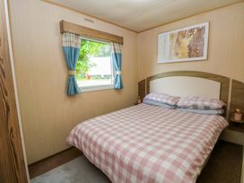 A bedroom with a bed and window at Kensington 49