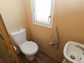 A bathroom with a toilet and hand basin at Kensington 49