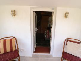 A doorway leading to a staircase with chairs at Tach Ferme