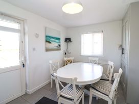 A dining room with a round table and chairs at Tach Ferme
