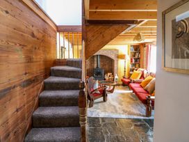 A living room with a staircase and sofa at Tach Ferme