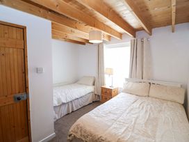 A bedroom with two beds and a bedside table at Tach Ferme