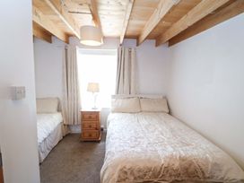 A bedroom with two beds and a bedside table at Tach Ferme