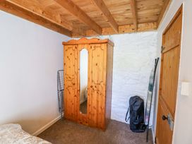 A bedroom with a wooden wardrobe and a backpack at Tach Ferme