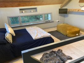 A bedroom with a bed and a bean bag at 1-Bed Barn Conversion, Sleeps 2 with Parking, Niwbwrch (newborough)