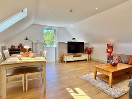 A living room with a dining table and chairs at Charming Barn Annex with Stables New Forest Escape