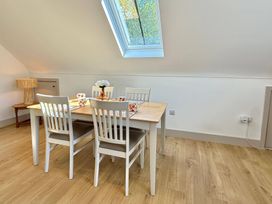 A dining room with a table and chairs at Charming Barn Annex with Stables New Forest Escape