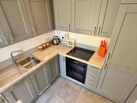 A kitchen with a sink and oven at Charming Barn Annex with Stables New Forest Escape