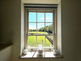 A window view with vases in front at Charming Barn Annex with Stables New Forest Escape