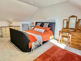 A bedroom with a bed and dresser at Charming Barn Annex with Stables New Forest Escape