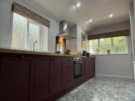 A kitchen with cabinets and a window at Llysawelon 2-Bed Cottage, Sleeps 5, Pets Ok Llysawelon near Llansteffan