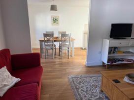 A living room with a sofa and a dining area at Apartment Sleeps 4 with Parking in Chagford