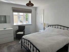 A bedroom with a bed and a chair at Apartment Sleeps 4 with Parking in Chagford