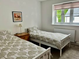 A bedroom with two beds and a lamp at Apartment Sleeps 4 with Parking in Chagford