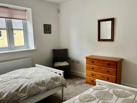 A bedroom with two beds and a dressing table at Apartment Sleeps 4 with Parking Chagford