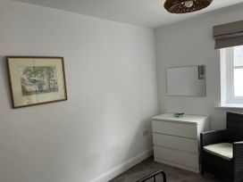 A bedroom with a drawing on the wall and a dressing table at Apartment Sleeps 4 with Parking Chagford