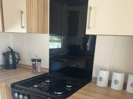 A kitchen with a gas stove and kettle at Caravan - Sleeps 6 - Parking in Lossiemouth