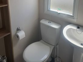 A bathroom with a toilet and sink at Caravan - Sleeps 6 - Parking in Lossiemouth