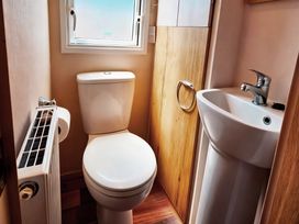 A bathroom with a toilet and sink at D&T Caravan Hire Southview Holiday Park Skegness