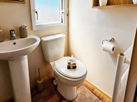 A bathroom with a sink and toilet at D&T Caravan Hire Southview Holiday Park Skegness