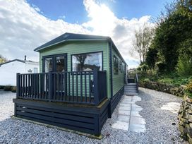 A cabin with a deck and steps at Coworth Deluxe Cabin with Garden