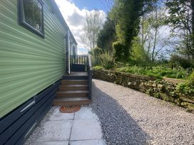 An outdoor pathway with steps and plants at Coworth Deluxe Cabin with Garden