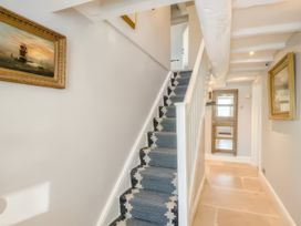 A hallway with a staircase and artwork at Cotswolds - Garden - Bbq - Parking - Sleeps 6 near Shipston-On-Stour