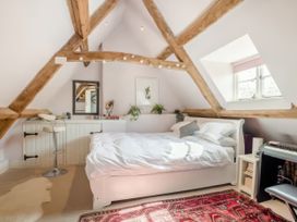 A bedroom with a bed and a chair at Cotswolds - Garden - Bbq - Parking - Sleeps 6 near Shipston-On-Stour