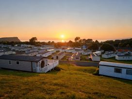 A view of caravans and sunset at Caravan Sleeps 6 with Sea Views and Parking in Ayr