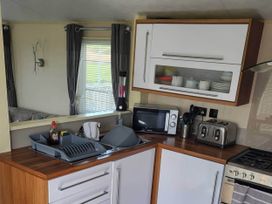 A kitchen with a sink and appliances at BandR Turnberry Escape Scotland in Girvan