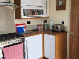 A kitchen with an oven and toaster at BandR Turnberry Escape Scotland in Girvan