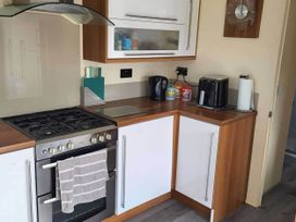 A kitchen with a gas stove and coffee machine at BandR Turnberry Escape Scotland in Girvan