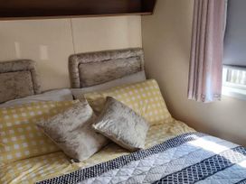 A bedroom with a bed and patterned bedding at BandR Turnberry Escape Scotland, Girvan