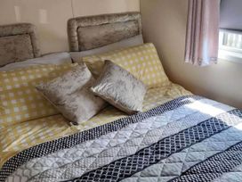 A bedroom with a bed and pillows at BandR Turnberry Escape Scotland in Girvan