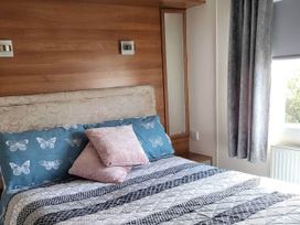 A bedroom with a bed and pillows at BandR Turnberry Escape Scotland Girvan
