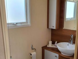 A bathroom with a sink and cabinet at BandR Turnberry Escape Scotland in Girvan