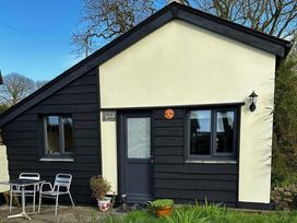 A small house with a door and windows at Little Linney in Hartland