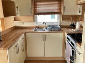 A kitchen with sink and cooking range at Beautiful 2 Bed Static caravan