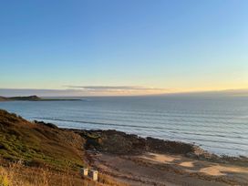 A beach view with ocean and rocks at Beautiful 2 Bed Static caravan