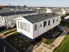 An image of a caravan with steps and grass area at Captivating 6-Person Caravan in Rhyl