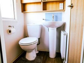 A bathroom with a toilet and sink at Captivating 6-Person Caravan in Rhyl