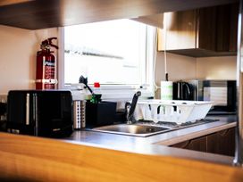 A kitchen with a sink, toaster, and fire extinguisher at Captivating 6-Person Caravan in Rhyl