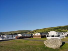 A view of caravans and hills at Sea and Mountain view Sunbeach Holiday Snowdonia in Llwyngwril