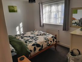 A bedroom with a bed and mirror at Ground Floor Cornish Retreat Free Parking in Bodmin