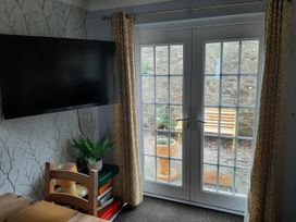 A snug with a television and a view of a garden at Ground Floor Cornish Retreat Free Parking in Bodmin