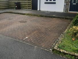 A driveway with a wheelie bin and a front door at Ground Floor Cornish Retreat Free Parking in Bodmin